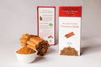 Ceylon Cinnamon quills, ground cinnamon, and a box of Cinnamon Heritage cinnamon quills on a white background