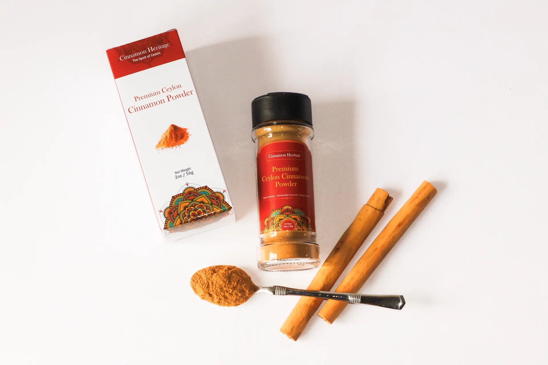 Ceylon Cinnamon powder packaging with cinnamon sticks and a spoonful of powder on a white background. Highest quality ceylon cinnamon.